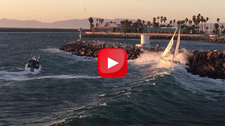 Out-of-control sailboat against the rocks